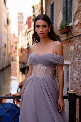 Lavender evening dress with draped off-shoulder tulle neckline, beaded corset bodice, and flowing skirt