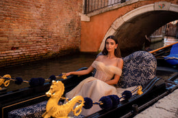 Lavender evening dress with a sheer beaded bodice and draped neckline, shown with its flowing skirt