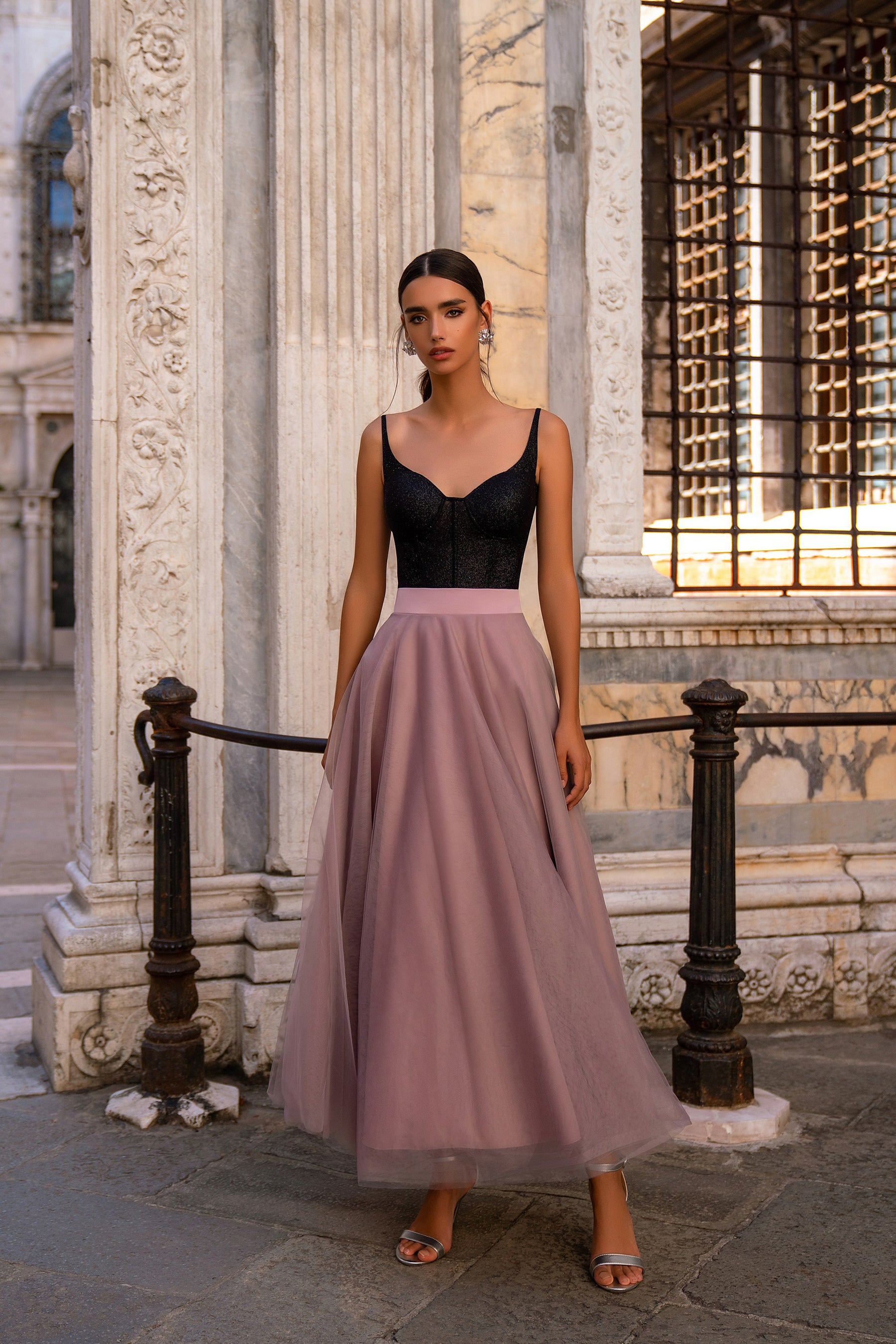Sleeveless evening dress with thin straps, a black bodice, and a flowing mauve floor-length skirt