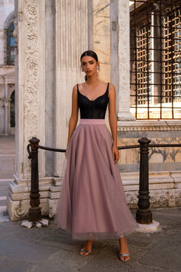 Sleeveless evening dress with thin straps, a black bodice, and a flowing mauve floor-length skirt