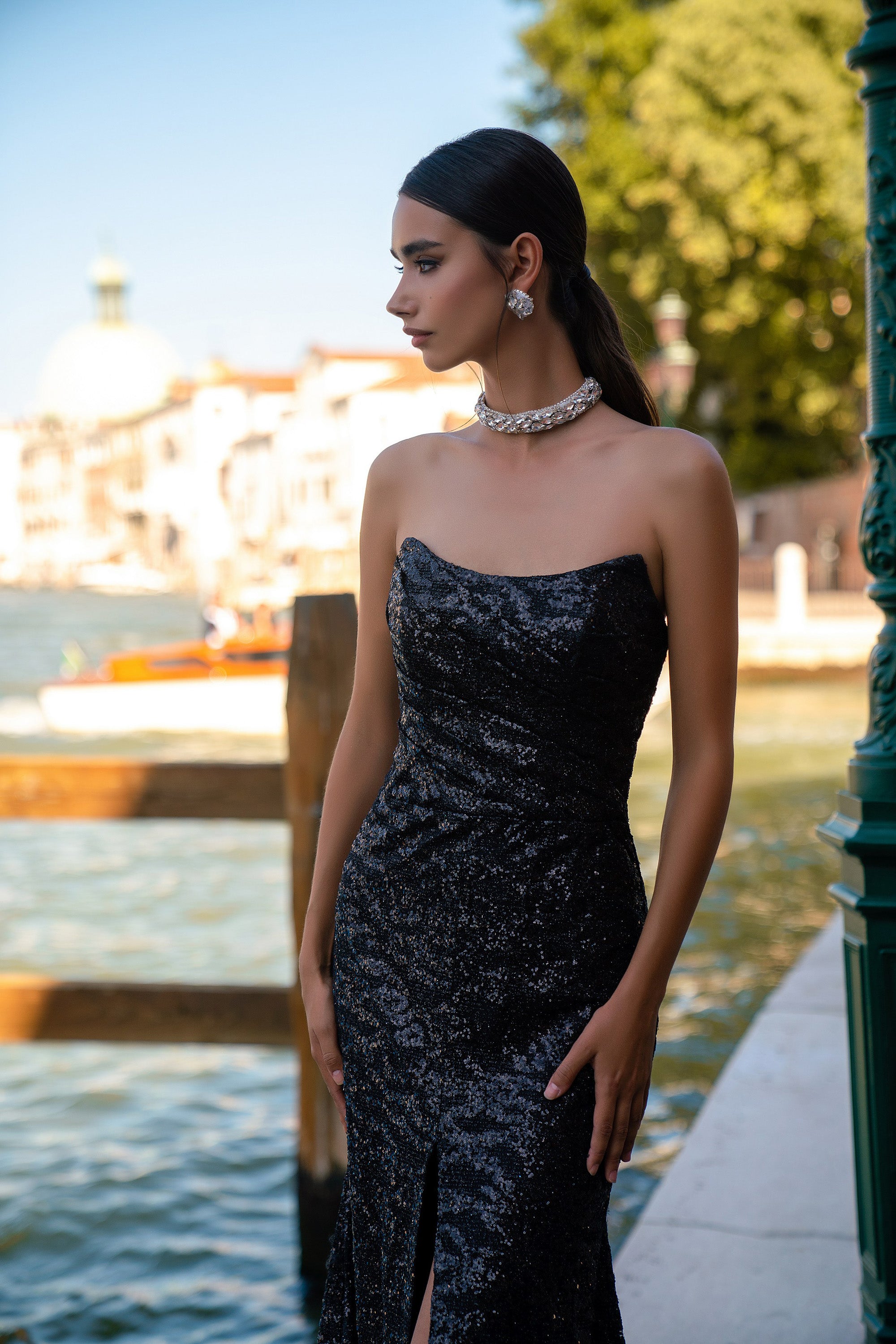 Black sequined evening dress with a strapless straight neckline and high front slit