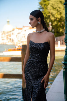Black sequined evening dress with a strapless straight neckline and high front slit
