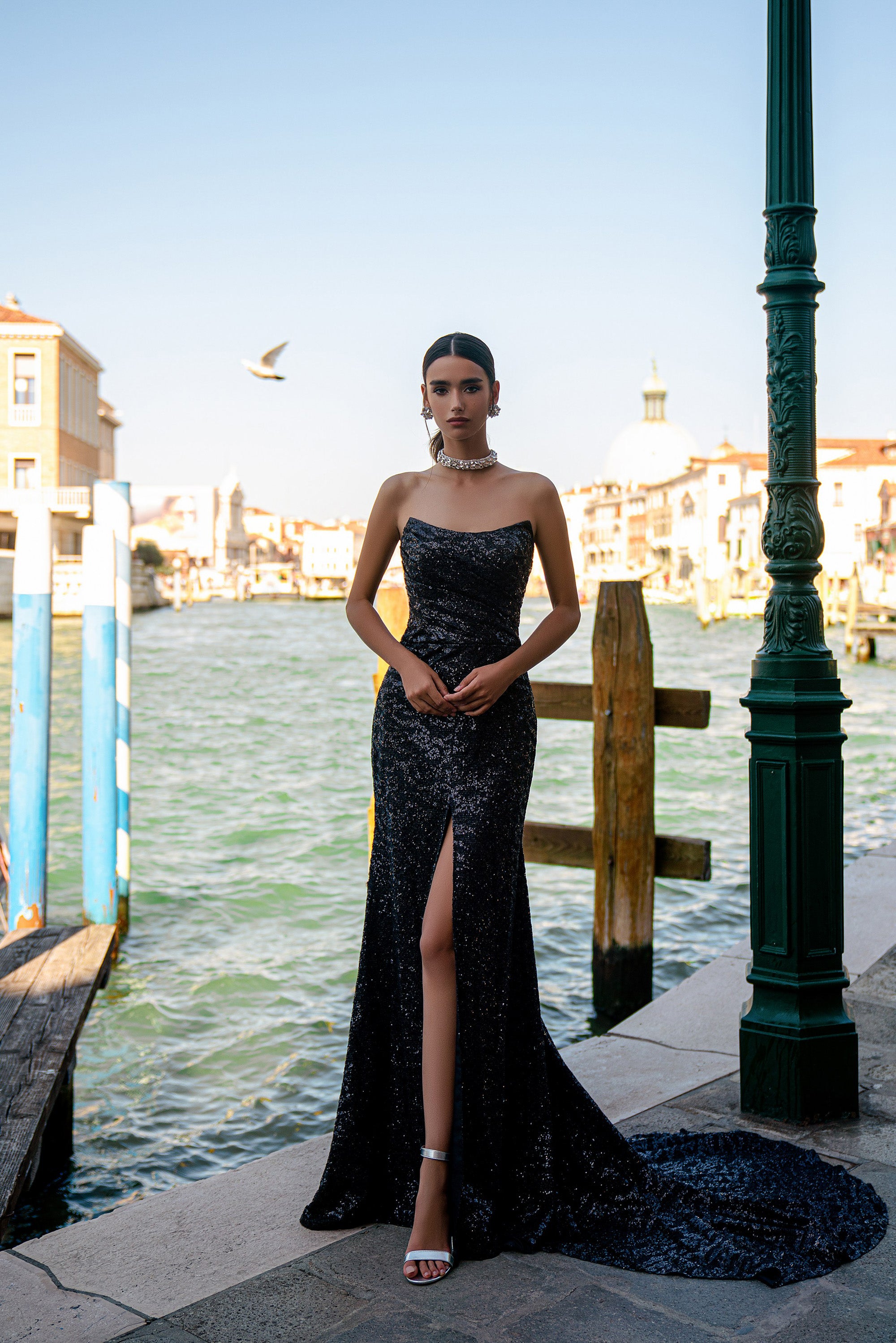 Black strapless sequined evening dress featuring a thigh-high slit and sweeping floor-length train