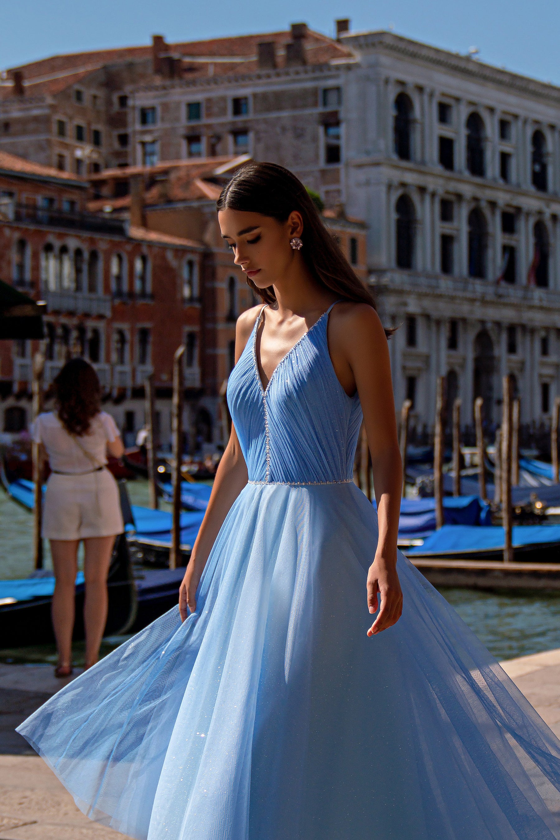 Blue evening dress with a sleeveless V-neck bodice and voluminous glittering full skirt