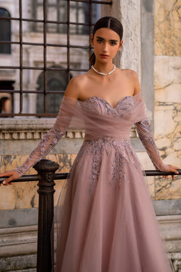 Mauve evening dress with an off-the-shoulder neckline, sheer sleeves, and sparkling floral embroidery