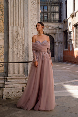 Flowing mauve evening dress with a sheer shoulder wrap, embellished bodice, and full floor-length skirt