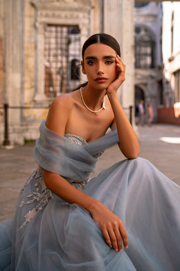 Blue-gray evening dress with a sweetheart neckline, sheer wrap, and floral embroidery on the bodice