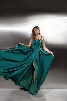 Emerald green evening dress with corset-style bodice, thin straps, front buttons, and thigh-high slit