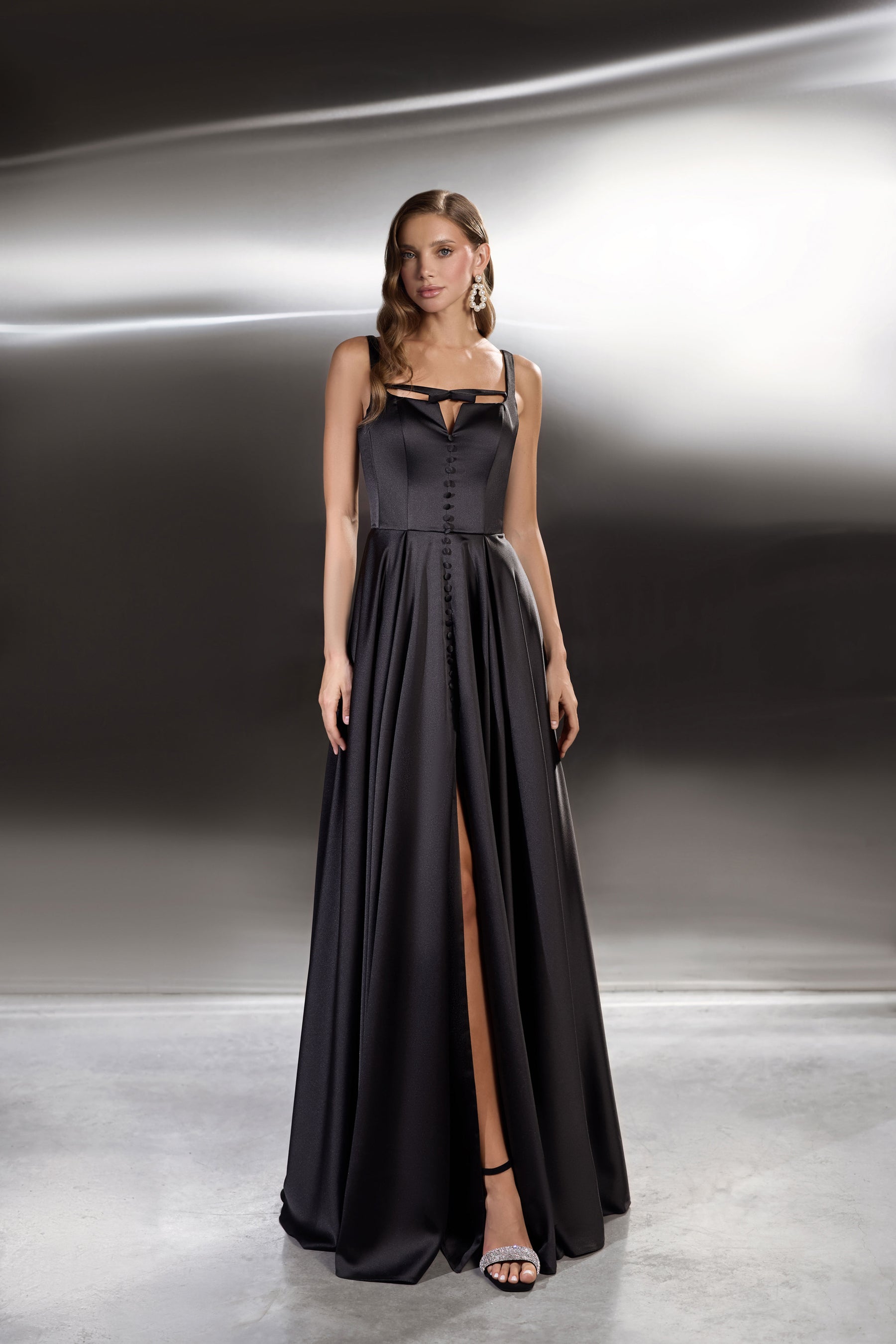 Black evening dress with square neckline, button-front bodice, full skirt, and high front slit