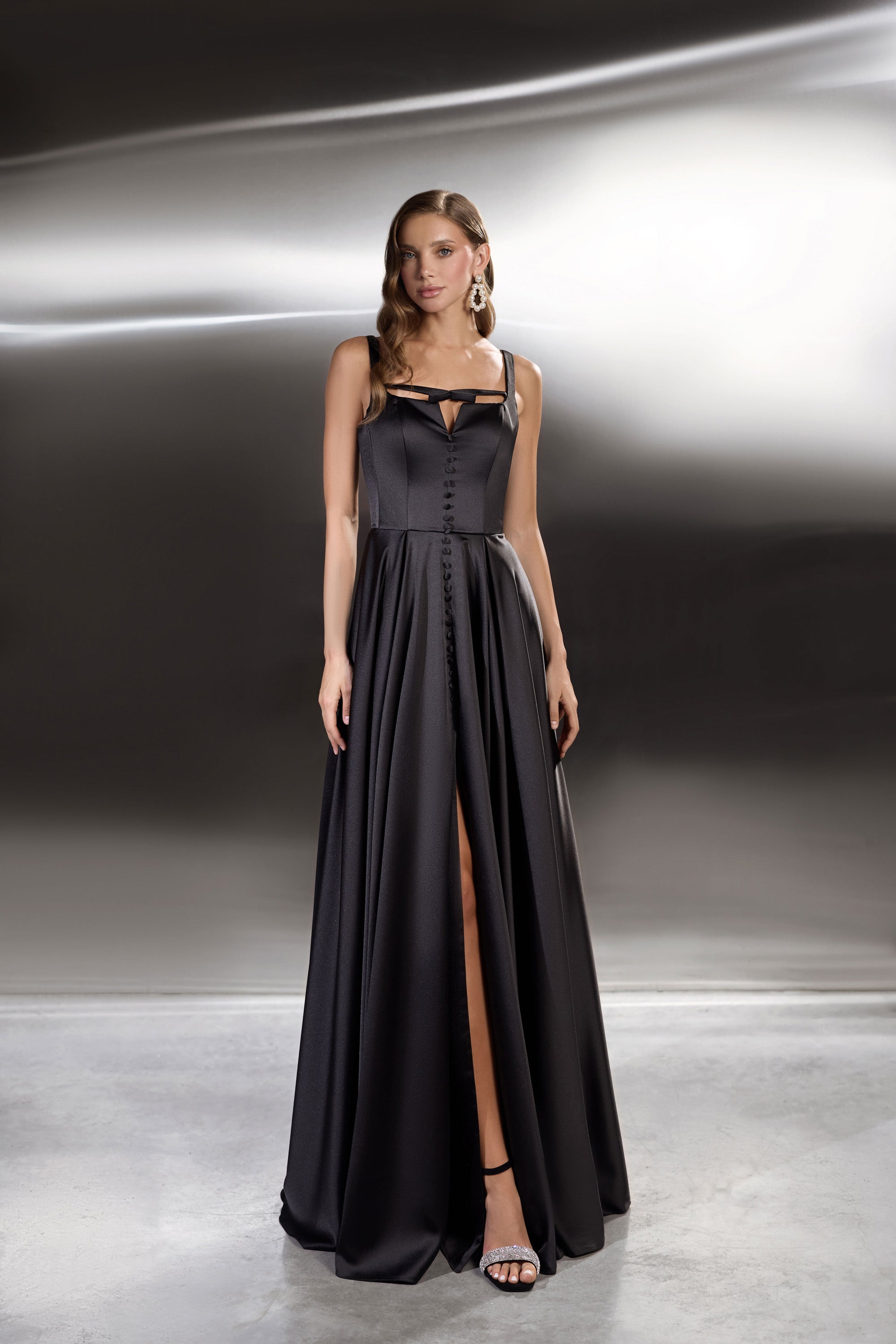 Black evening dress with square neckline, button-front bodice, full skirt, and high front slit