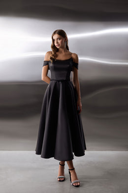 Black evening dress with an off-shoulder neckline, fitted bodice, and flowing full-length skirt