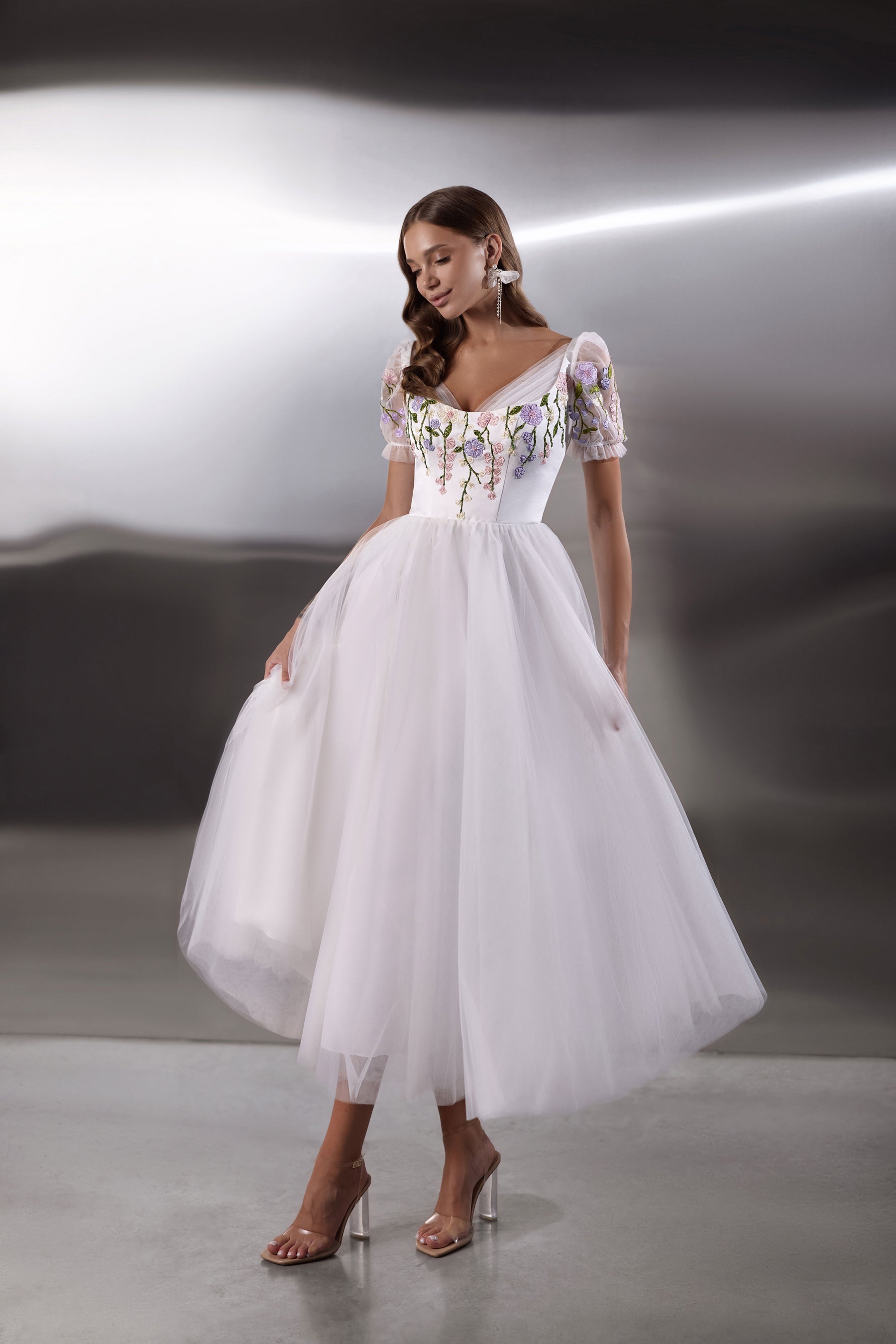 White evening dress with floral embroidered bodice, puff sleeves, square neckline, and full tulle skirt