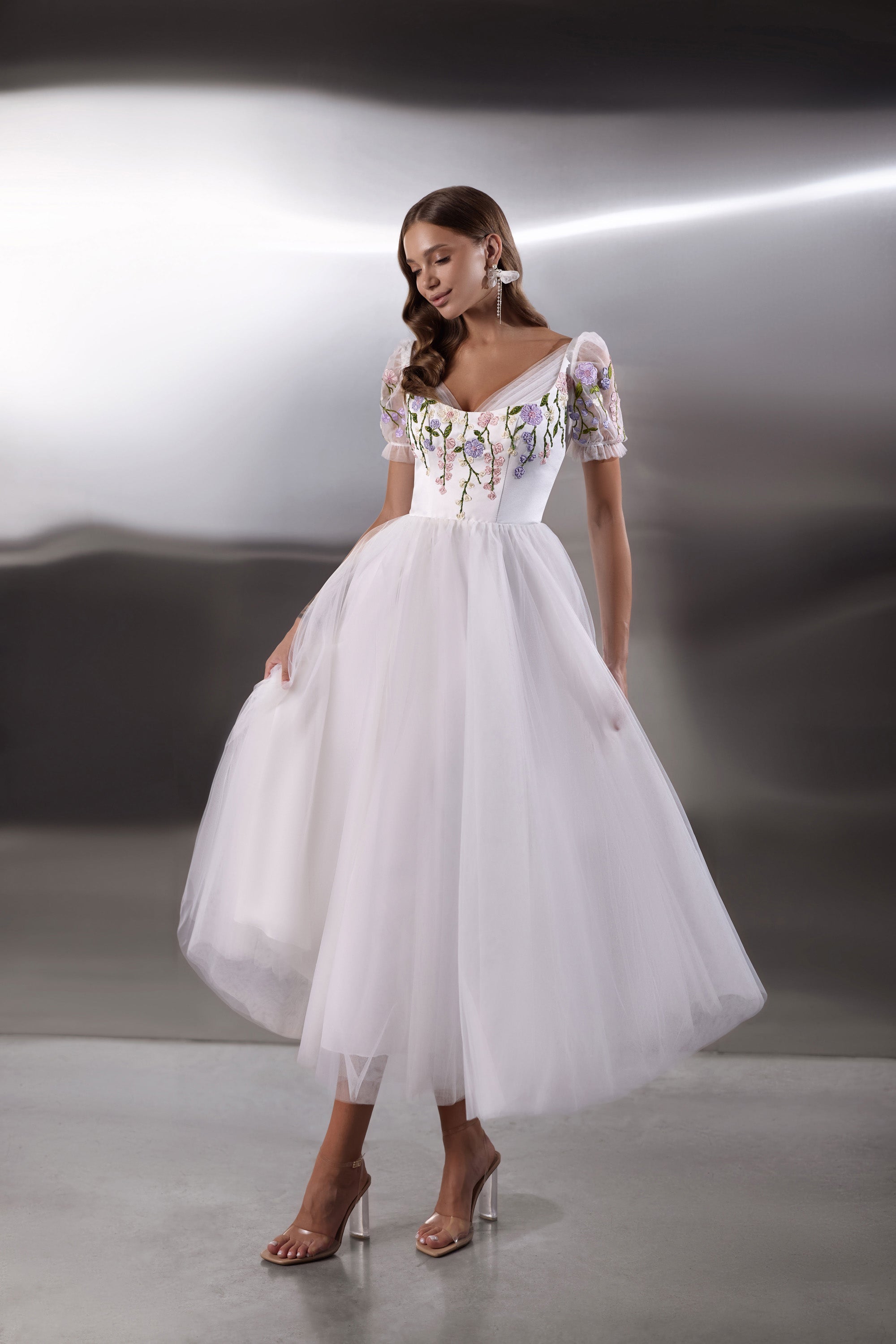 White evening dress with floral embroidered bodice, puff sleeves, square neckline, and full tulle skirt
