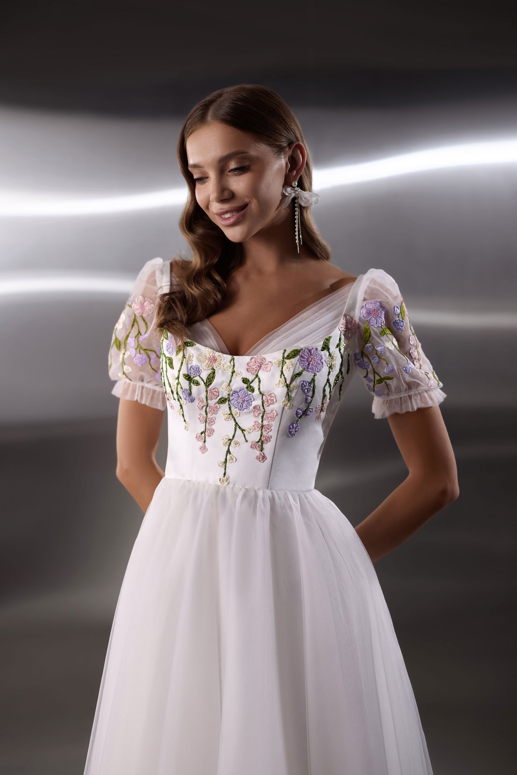 Floral embroidered bodice with sheer puff sleeves and a square neckline on a white evening dress
