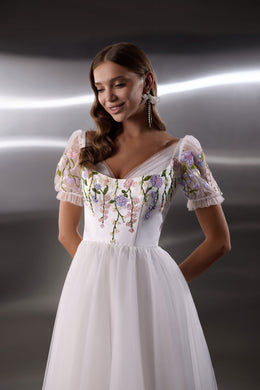 Floral embroidered bodice with sheer puff sleeves and a square neckline on a white evening dress