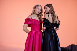 Pink evening dress with a draped off-shoulder neckline, thin straps, fitted waist, and full skirt