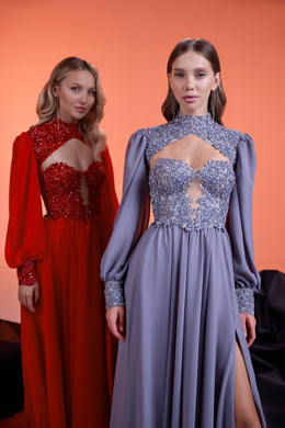 Lavender-gray evening dress with a crystal-embellished bodice, cutout neckline, sheer sleeves, and thigh-high slit