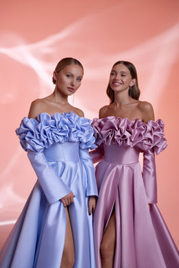 Close-up of blue and mauve evening dresses with sculptural ruffled off-the-shoulder necklines and satin bodices