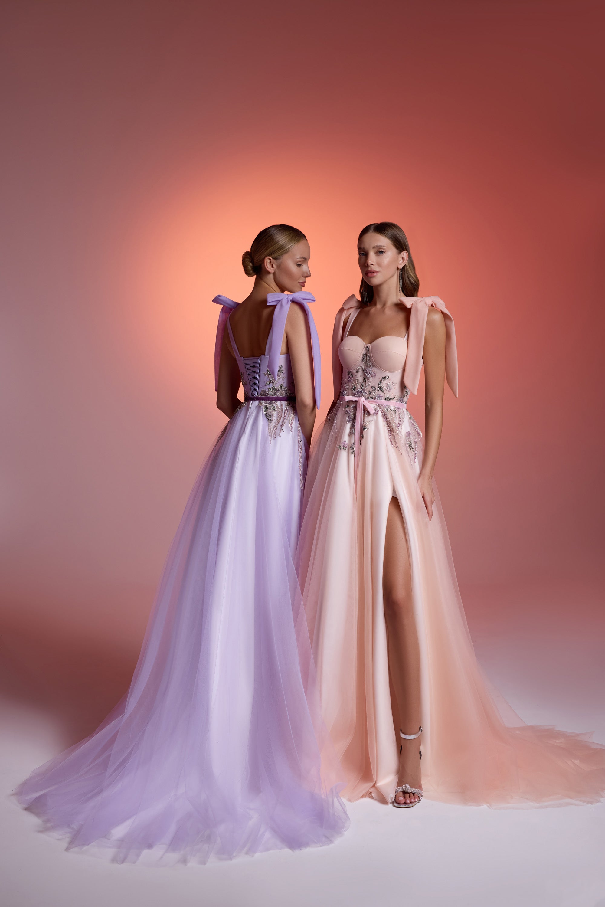 Lavender evening dress with an open lace-up back, flowing skirt, and long train
