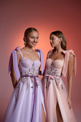 Close-up of pastel evening dress bodices with sweetheart necklines, crystal floral beadwork, and shoulder bows