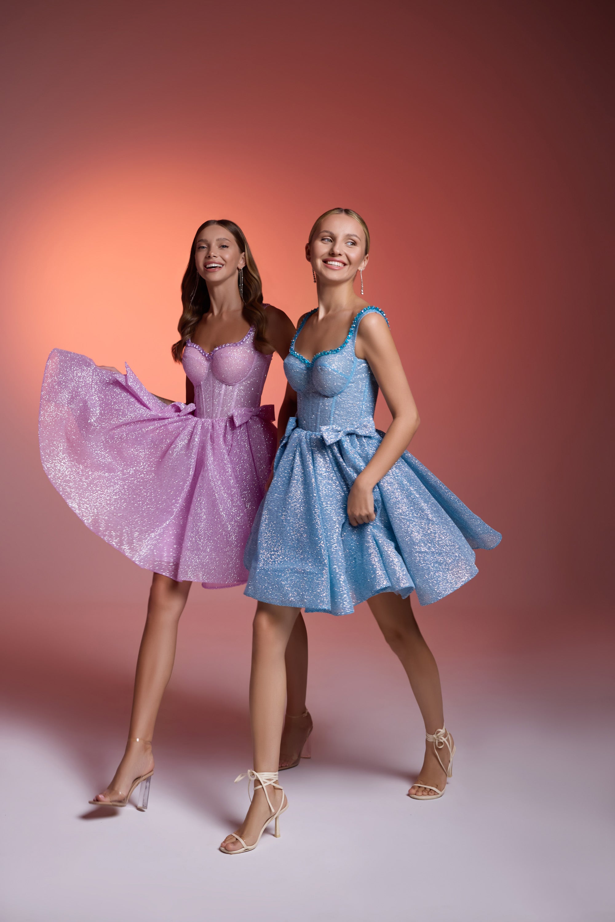 Sparkling pink and blue evening dresses with scoop necklines and flared knee-length skirts
