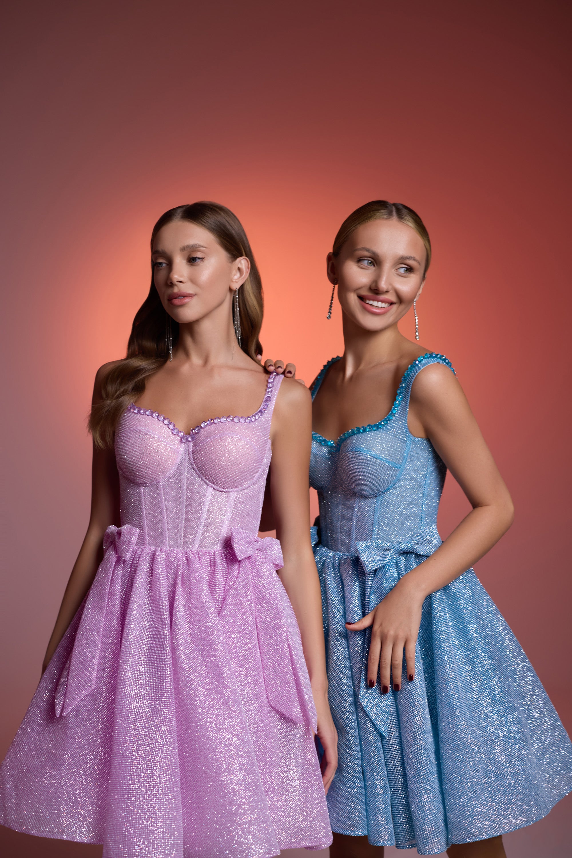Pink and blue glitter evening dresses with scoop necklines, fitted bodices, bow waists, and flared skirts