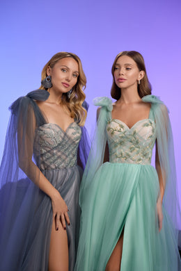 Close-up of the charcoal evening dress's jeweled sweetheart bodice, sheer sleeves, and thigh-high slit