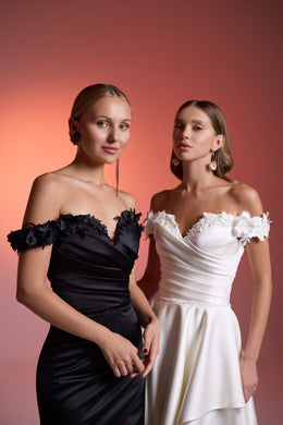 Black and white off-the-shoulder evening dresses with ruched bodices and floral-trimmed necklines