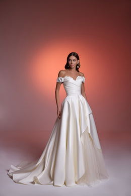 White off-the-shoulder evening dress with a ruched bodice, layered skirt, and long flowing train