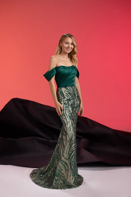 Emerald green evening dress with off-shoulder sleeves, crystal-embellished fitted skirt, and sweeping train