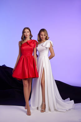 White evening dress with a draped one-shoulder neckline, high slit, and long trailing train