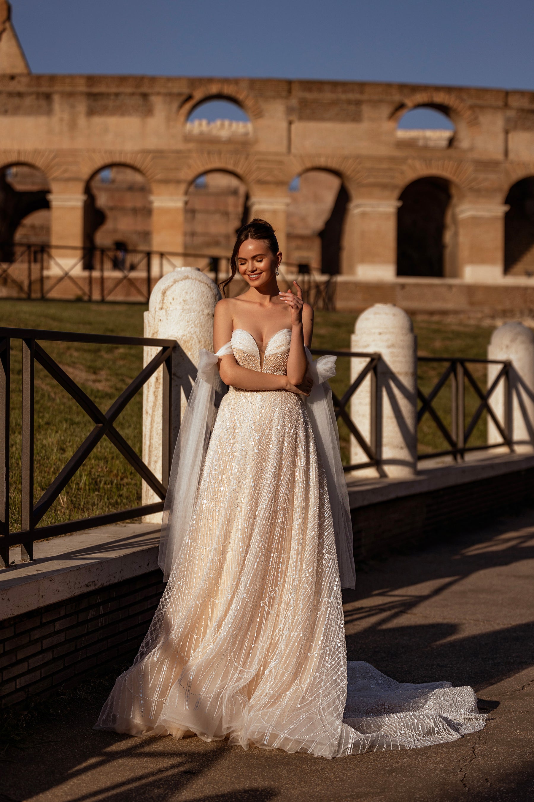 Sparkling ivory A-line wedding dress with a sweetheart neckline, sheer detachable sleeves, and trailing train