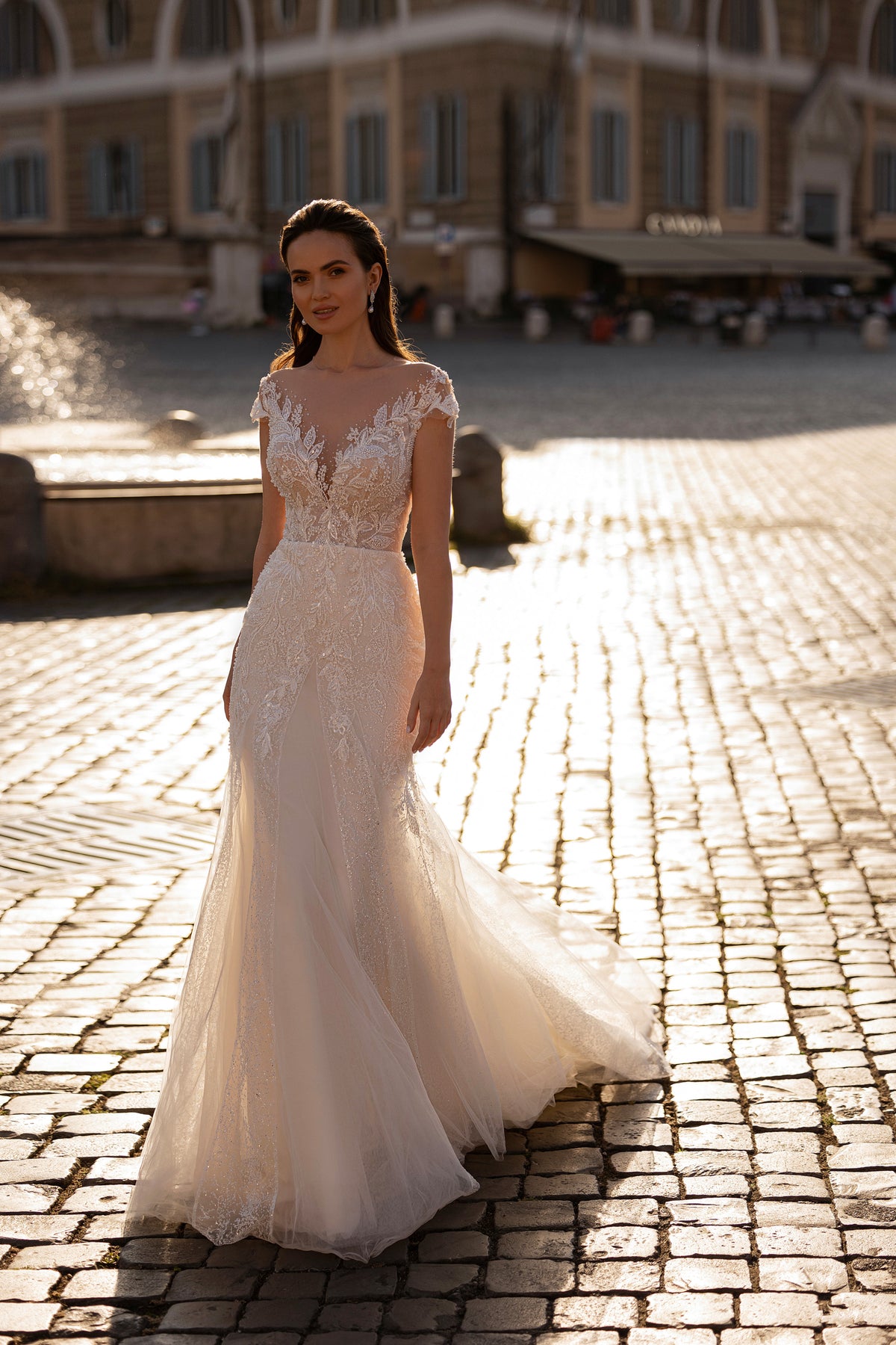 Ivory mermaid wedding dress with beaded lace bodice, illusion neckline, cap sleeves, and sweeping train