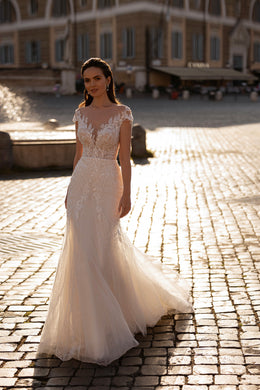 Ivory mermaid wedding dress with beaded lace bodice, illusion neckline, cap sleeves, and sweeping train