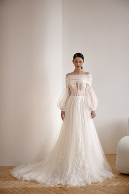 Ivory A-line wedding dress with an off-the-shoulder neckline, sheer sleeves, floral lace, and a long train