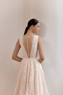 Close-up of the sheer illusion back with lace panels on a blush A-line wedding dress
