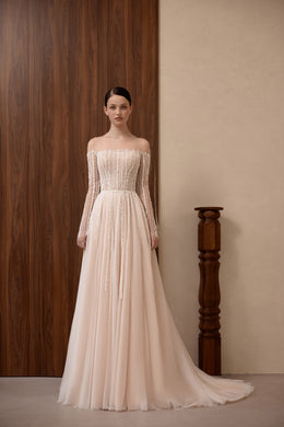 Blush A-line wedding dress with beaded sheer sleeves, an off-the-shoulder neckline, and a flowing train