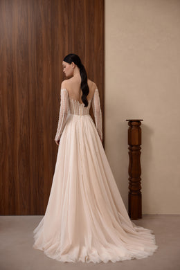 Open-back wedding dress with beaded sheer long sleeves, a full A-line skirt, and a sweeping train