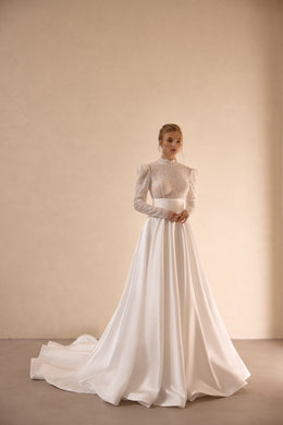 Ivory A-line wedding dress with a high neck, sparkling long sleeves, full skirt, and sweeping train