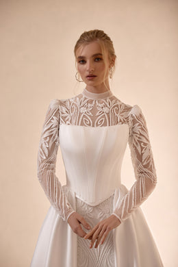 High-neck wedding dress with sheer floral lace sleeves and a structured white corset bodice