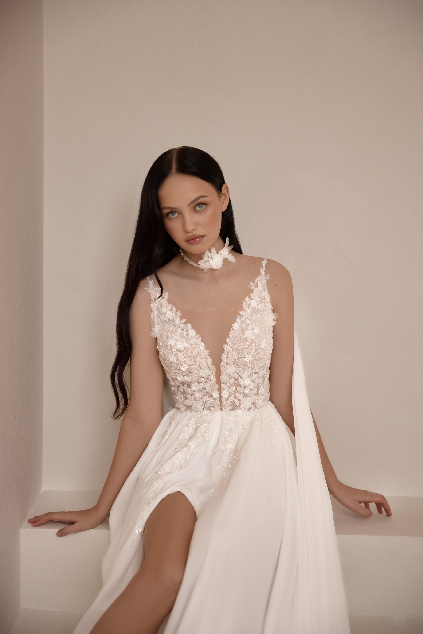 Ivory wedding dress with a sheer floral lace bodice, deep V-neckline, and high front slit