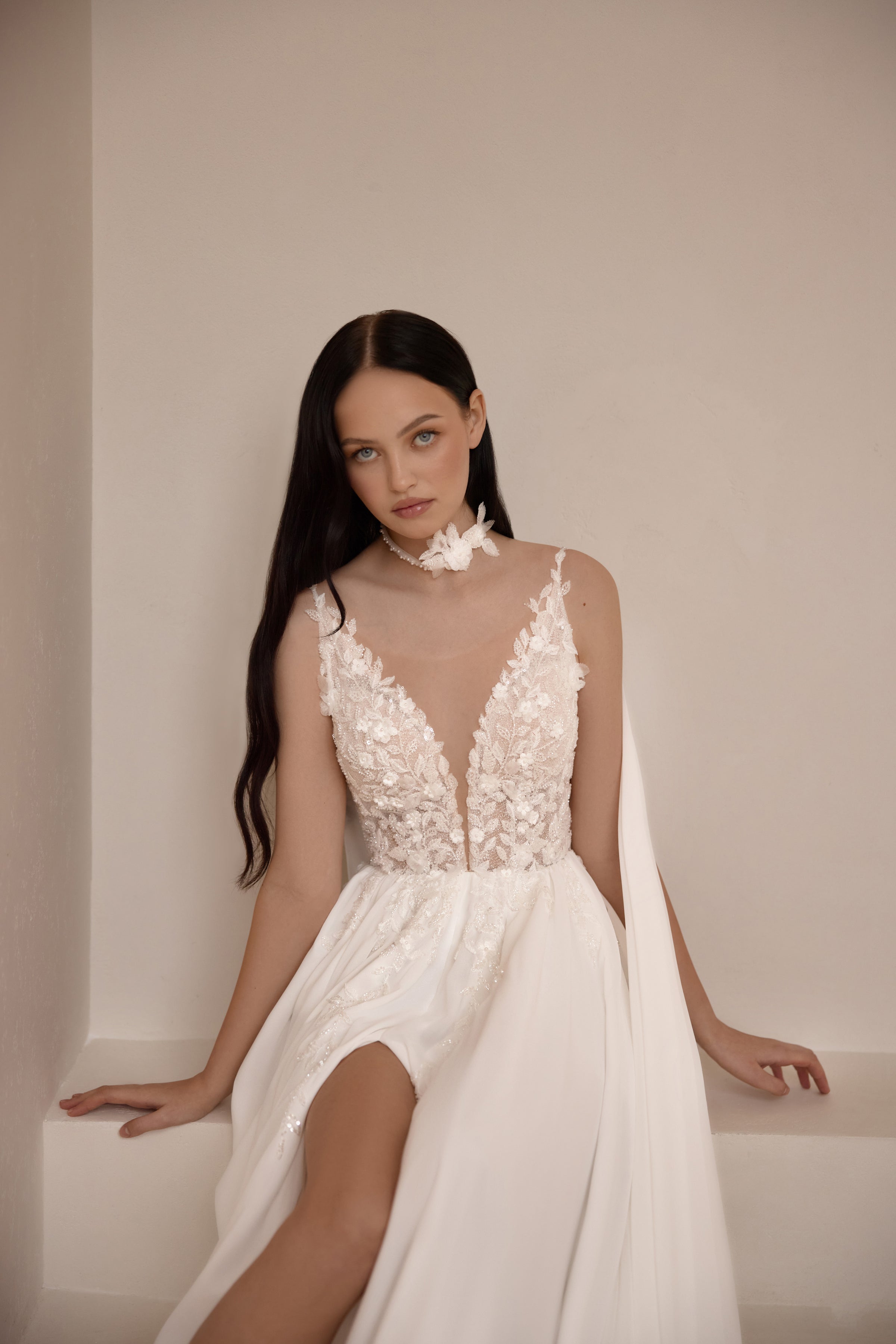 Ivory wedding dress with a sheer floral lace bodice, deep V-neckline, and high front slit