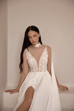 Ivory wedding dress with a sheer floral lace bodice, deep V-neckline, and high front slit
