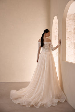 Ivory wedding dress with a beaded off-the-shoulder back, long sleeves, and sweeping train