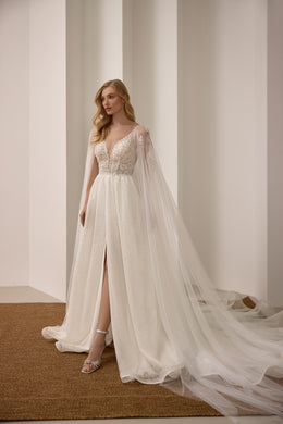 Sparkling ivory A-line wedding dress with a deep V-neck, front slit, and flowing sheer cape