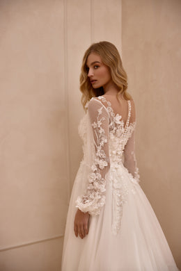 Open V-back ivory wedding dress with floral lace sleeves, appliqué details, and a sweeping train