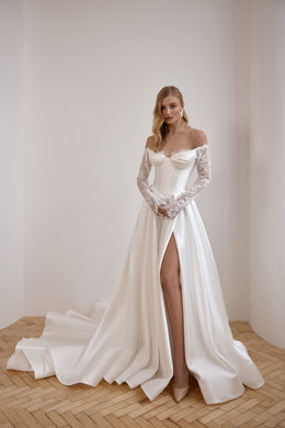 Ivory wedding dress with an off-the-shoulder neckline, lace sleeves, thigh-high slit, and long train