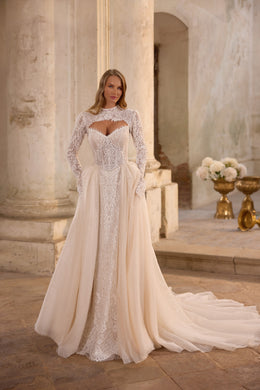 Full-length ivory wedding dress with a lace long-sleeve bolero, sparkling skirt, and extended train