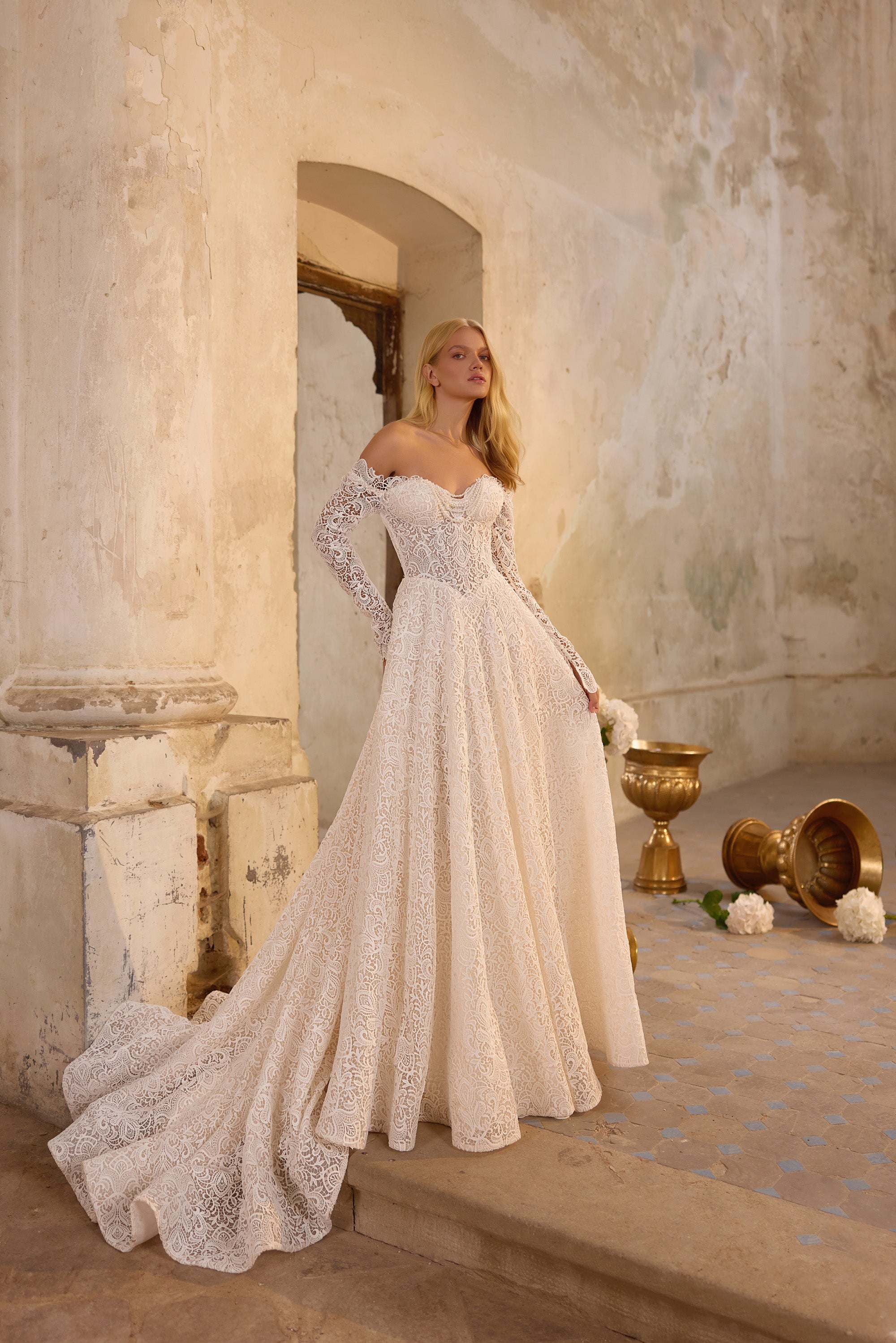 Ivory A-line wedding dress with off-the-shoulder lace sleeves, floral lace, and a sweeping train