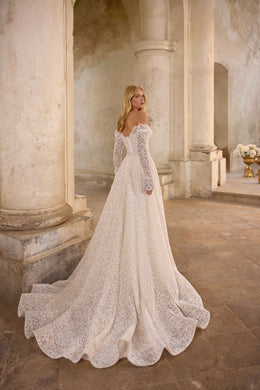 Lace wedding dress shown from the rear with long sleeves, an A-line skirt, and a wide scalloped train